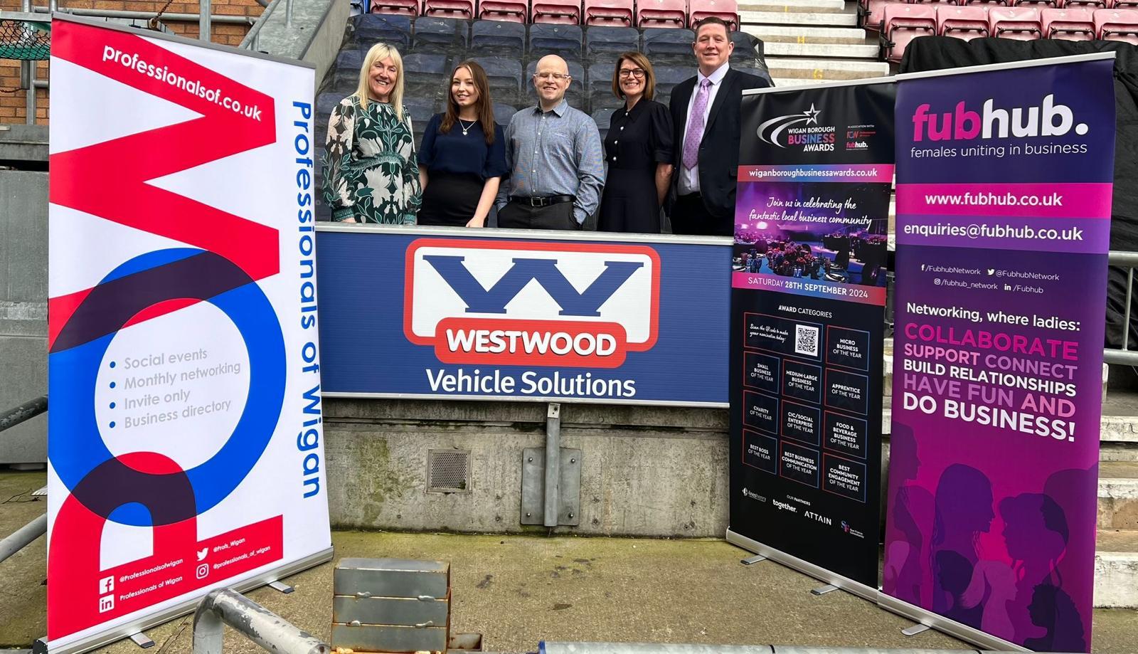 5 people behind westwood vehicle solutions banner